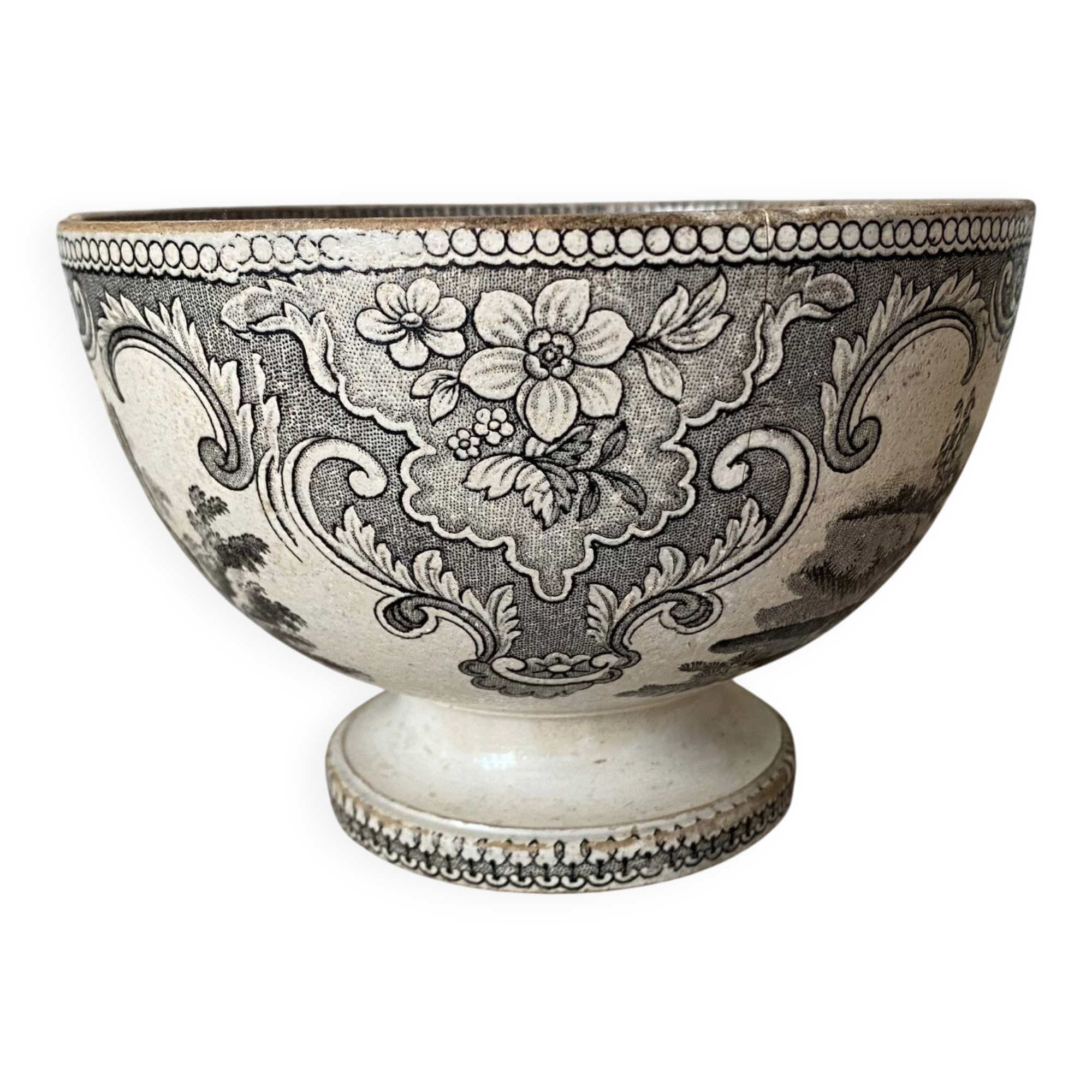 Old bowl made of iron with ceramic seams.