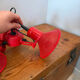 Three-lamp suspension in Memphis design style in red metal.
