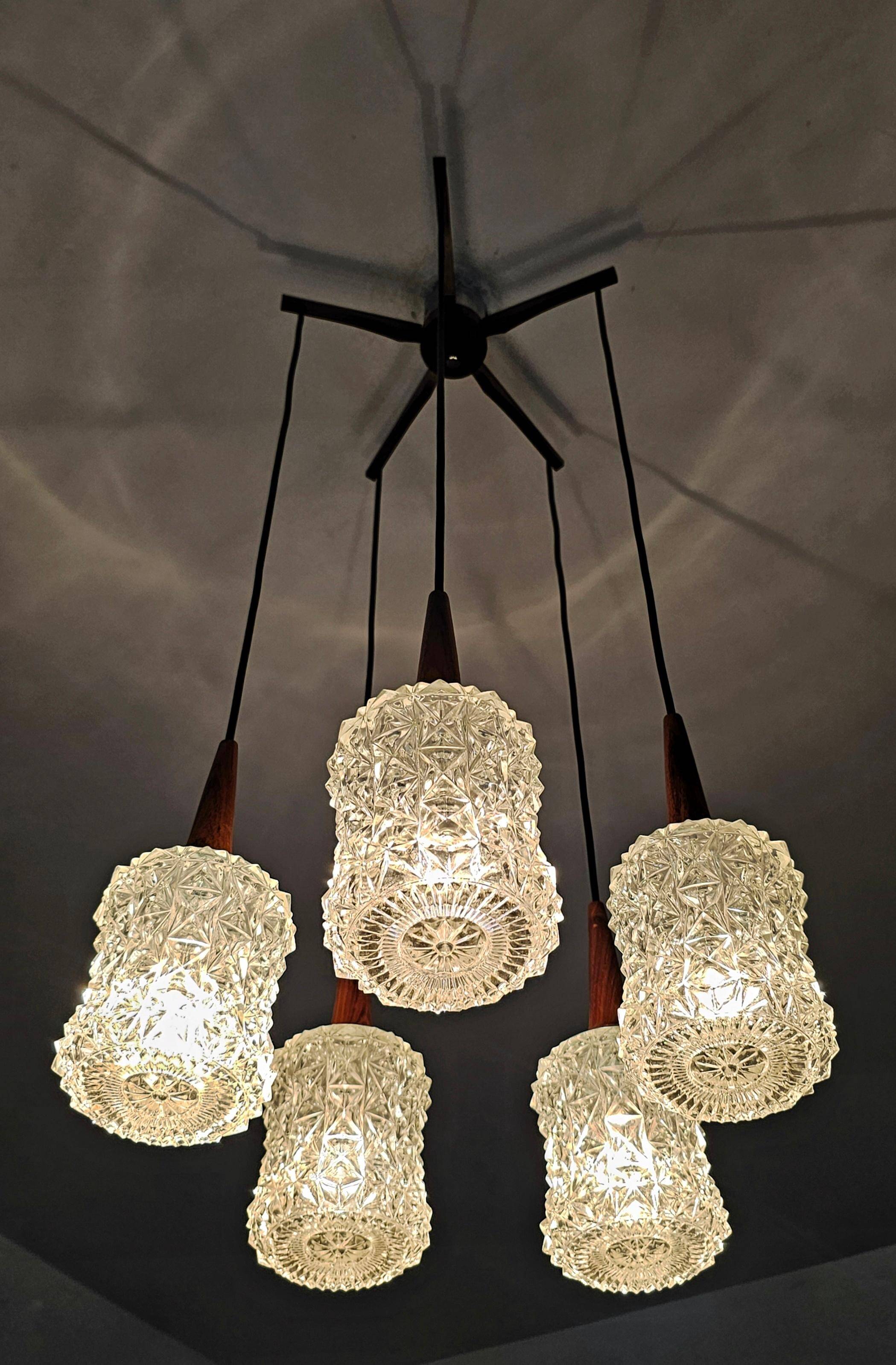 Mid Century Modern spider chandelier in teak, rosewood, and crystal.
