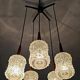 Mid Century Modern spider chandelier in teak, rosewood, and crystal.