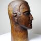 Monoxyle wood sculpture of a man's head, vintage craftsmanship from the 1950s.