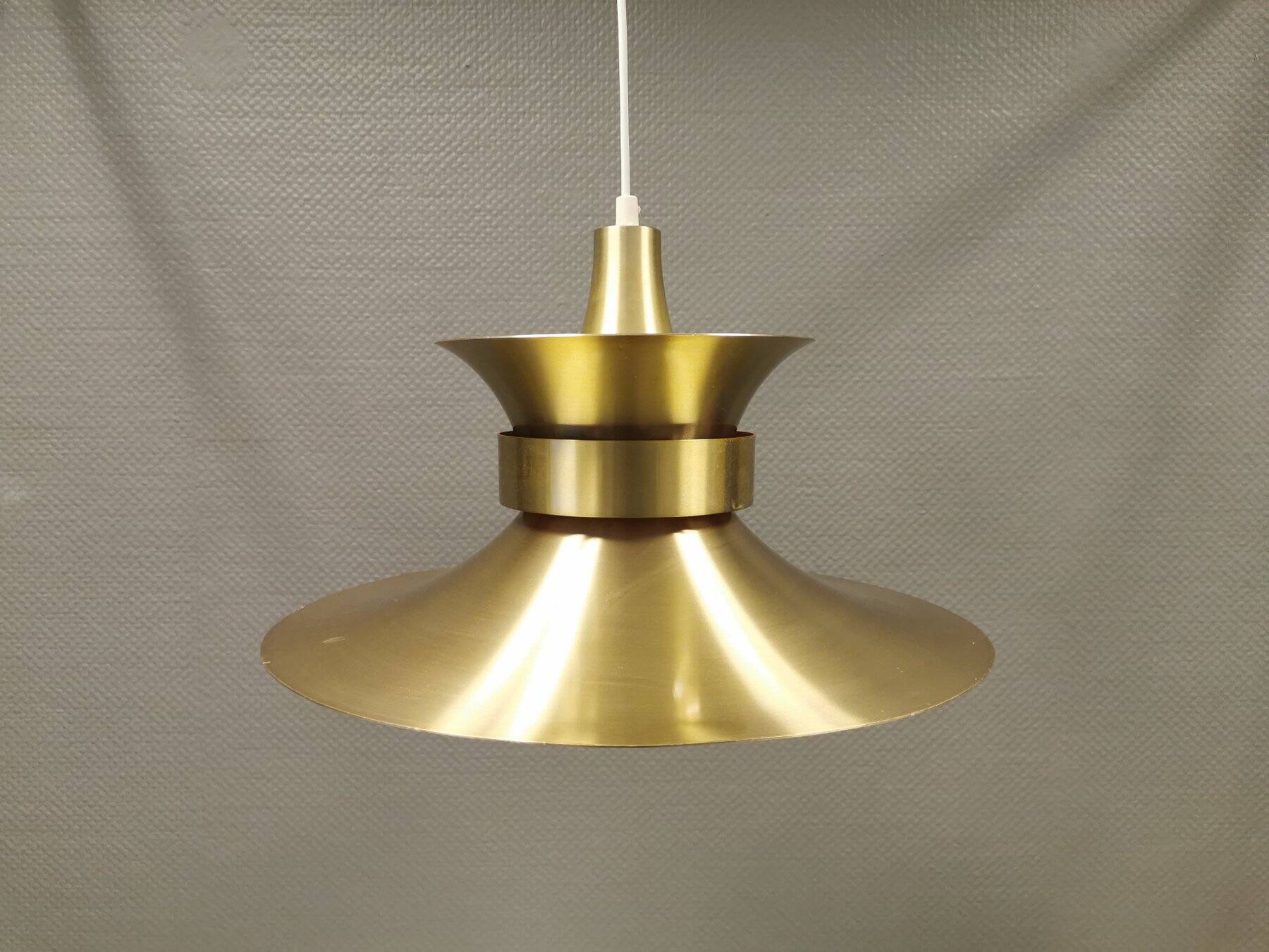 Large hanging lamp, made of brass-coloured aluminium with red and white contrast lacquer inside.