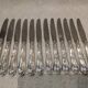 12 silver-plated dessert knives by St Medard, rocaille style, Florian.