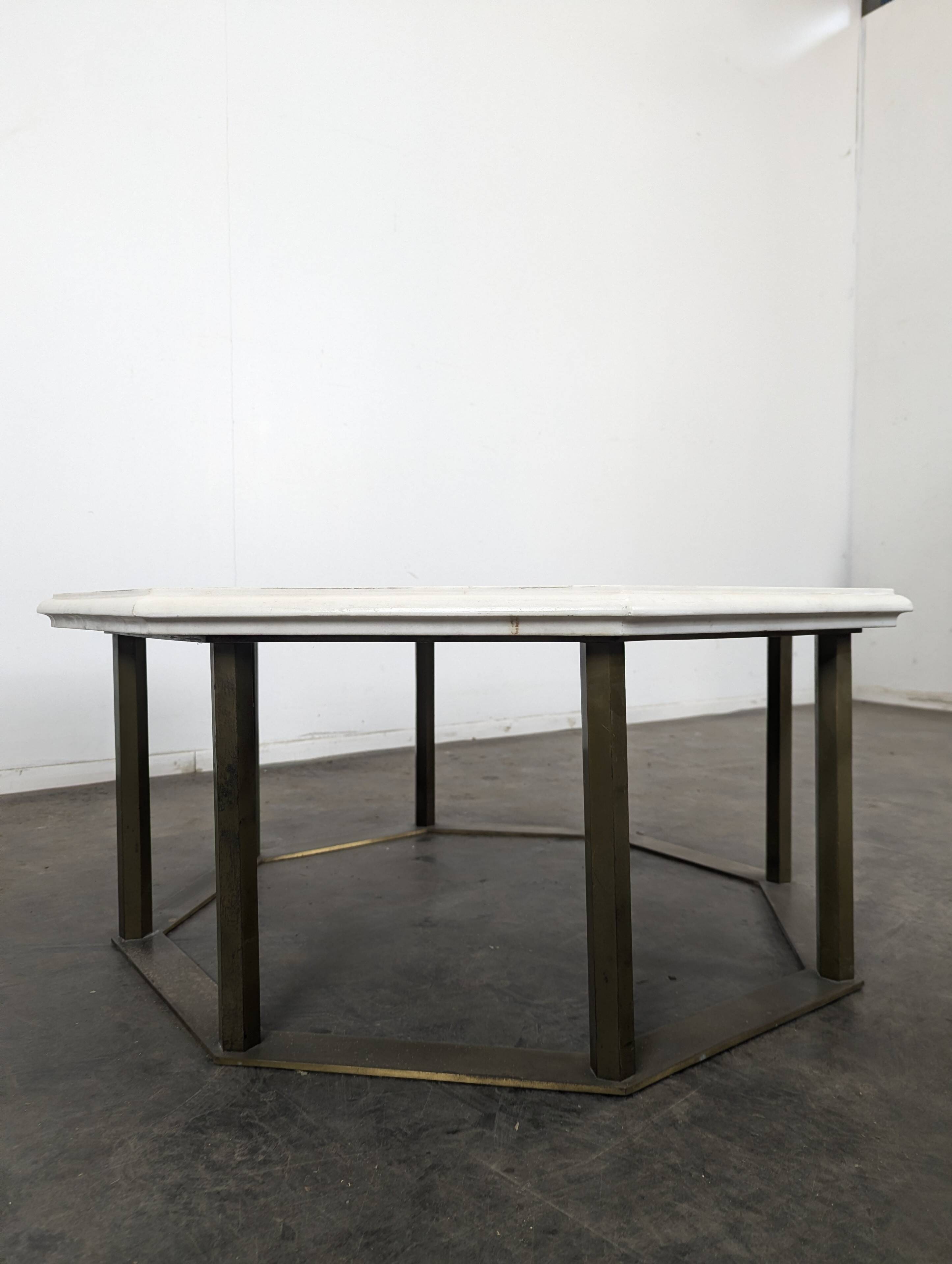 1940s octagonal coffee table with a marble top.