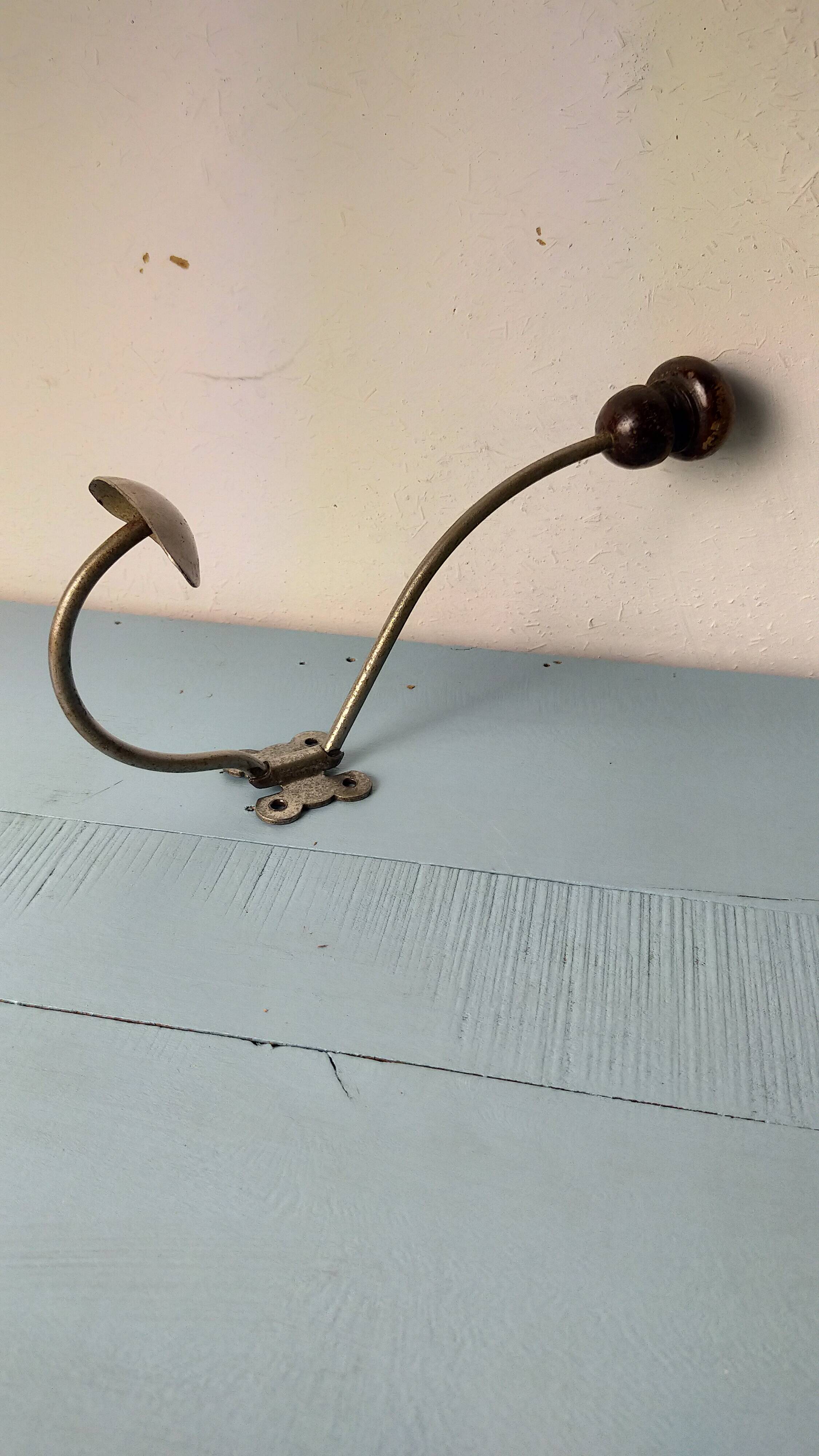 Antique coat rack with red wooden ball