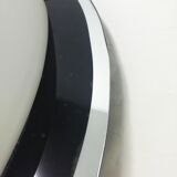 Oval wall lamp with mirror frame. 1980s 18x30cm
