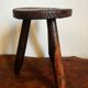 Tabouret tripode en bois sculpté