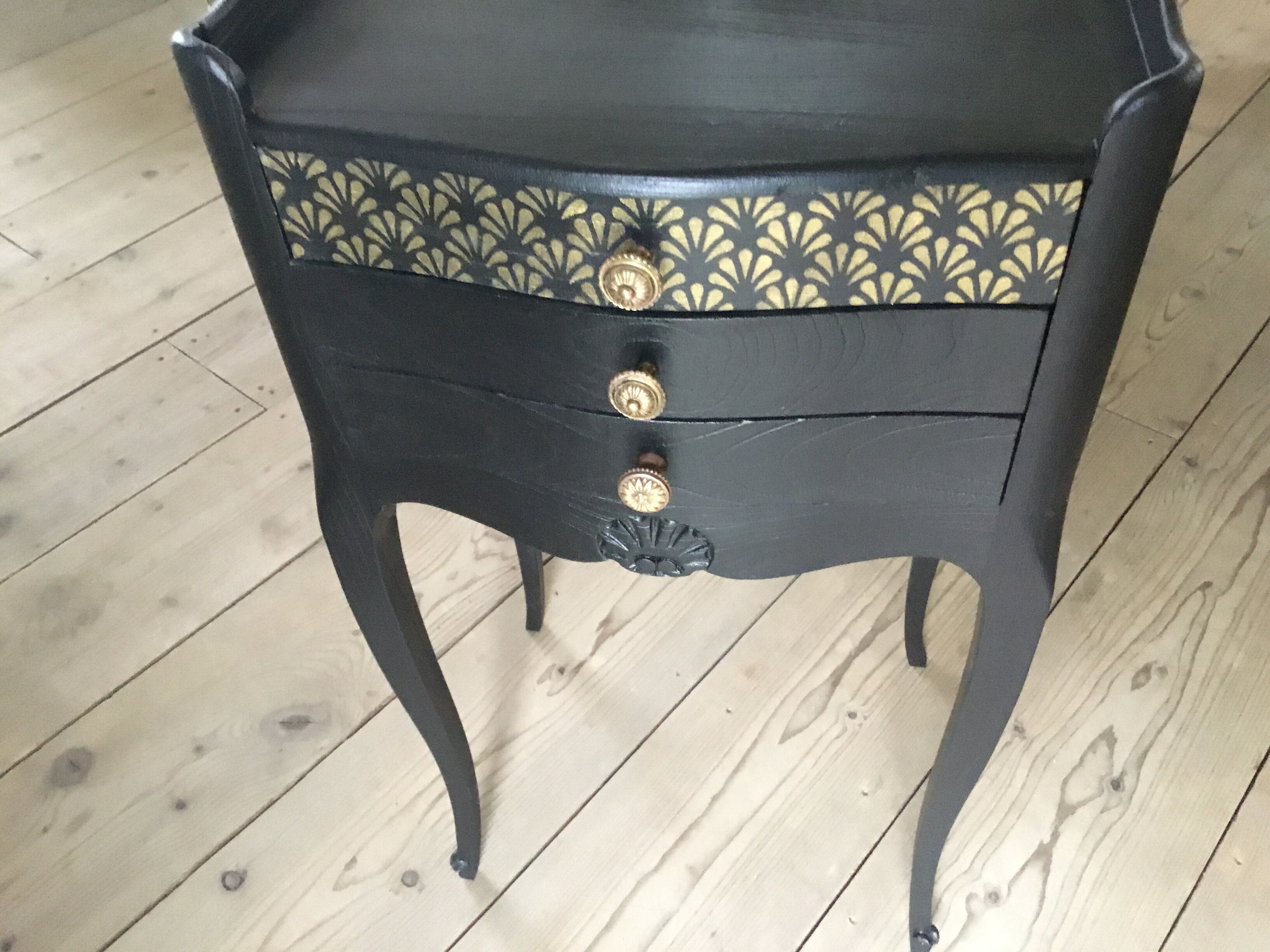 Bedside or nightstand painted black with patterns