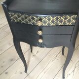 Bedside or nightstand painted black with patterns