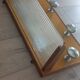 1950s coat rack with mirror, metal hooks, and glass shelf.