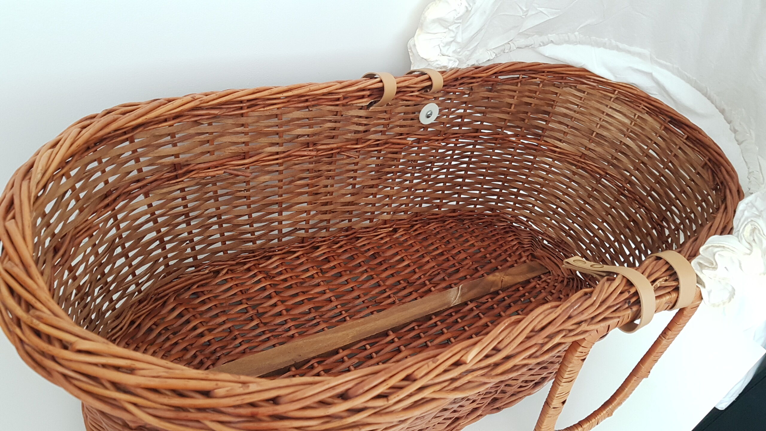 Old rattan bassinet and bedding