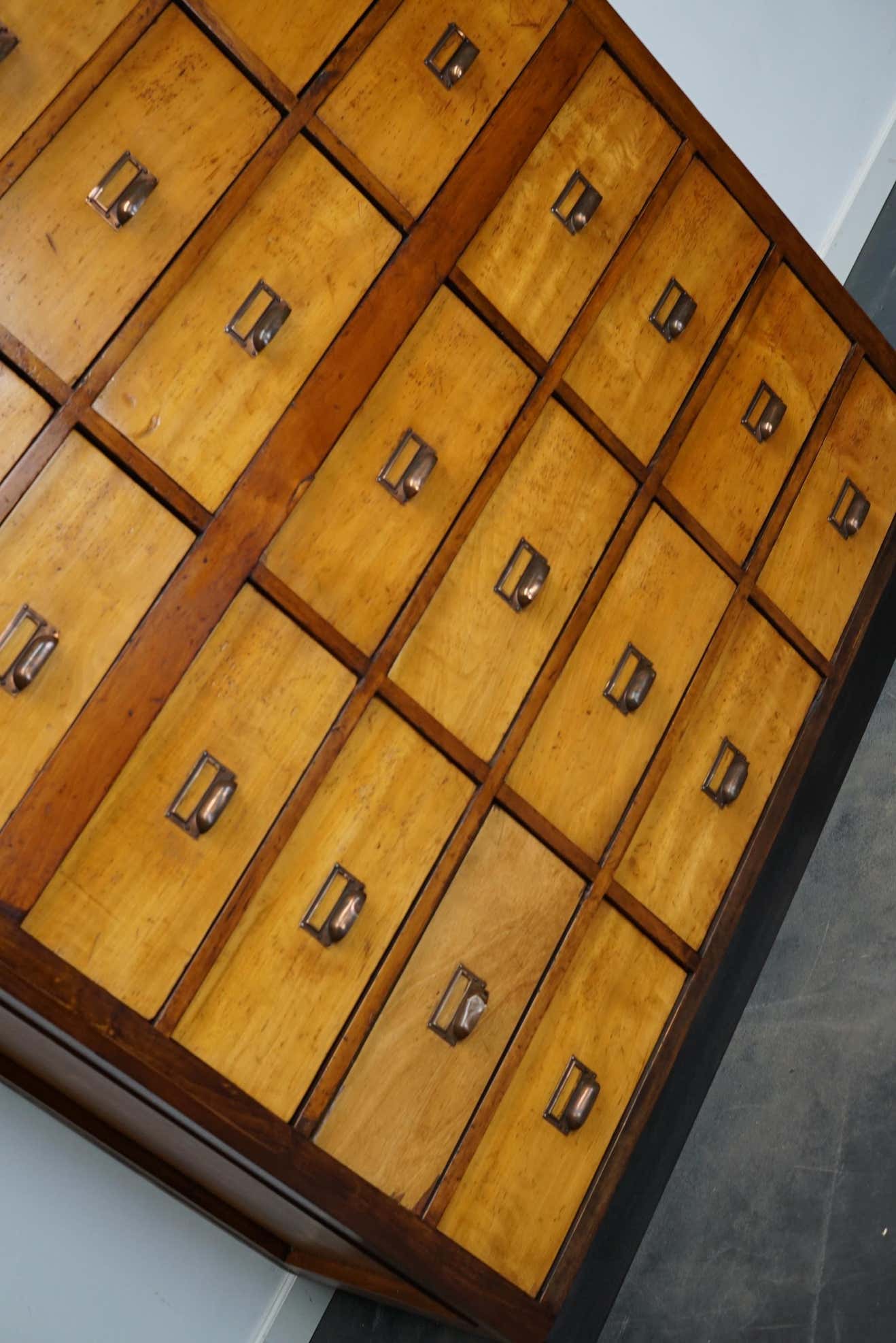 School cabinet bank of vintage Dutch drawers in mid-twentieth century pine