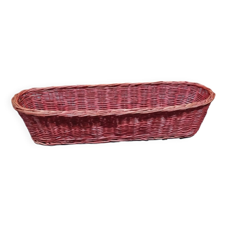 Old bread basket for baguette or red banneton in woven wicker