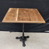 Bistro table with cast iron base and teak top