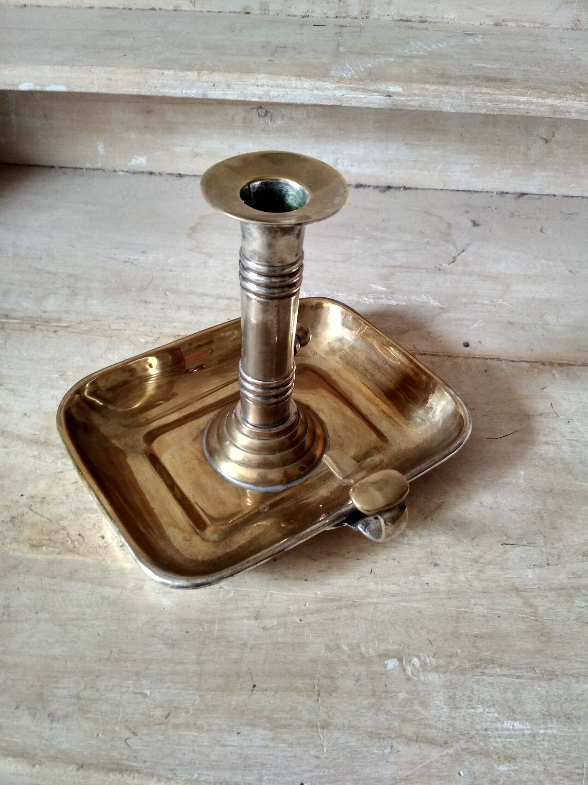 Antique metal and brass hand candle holder on rectangular base