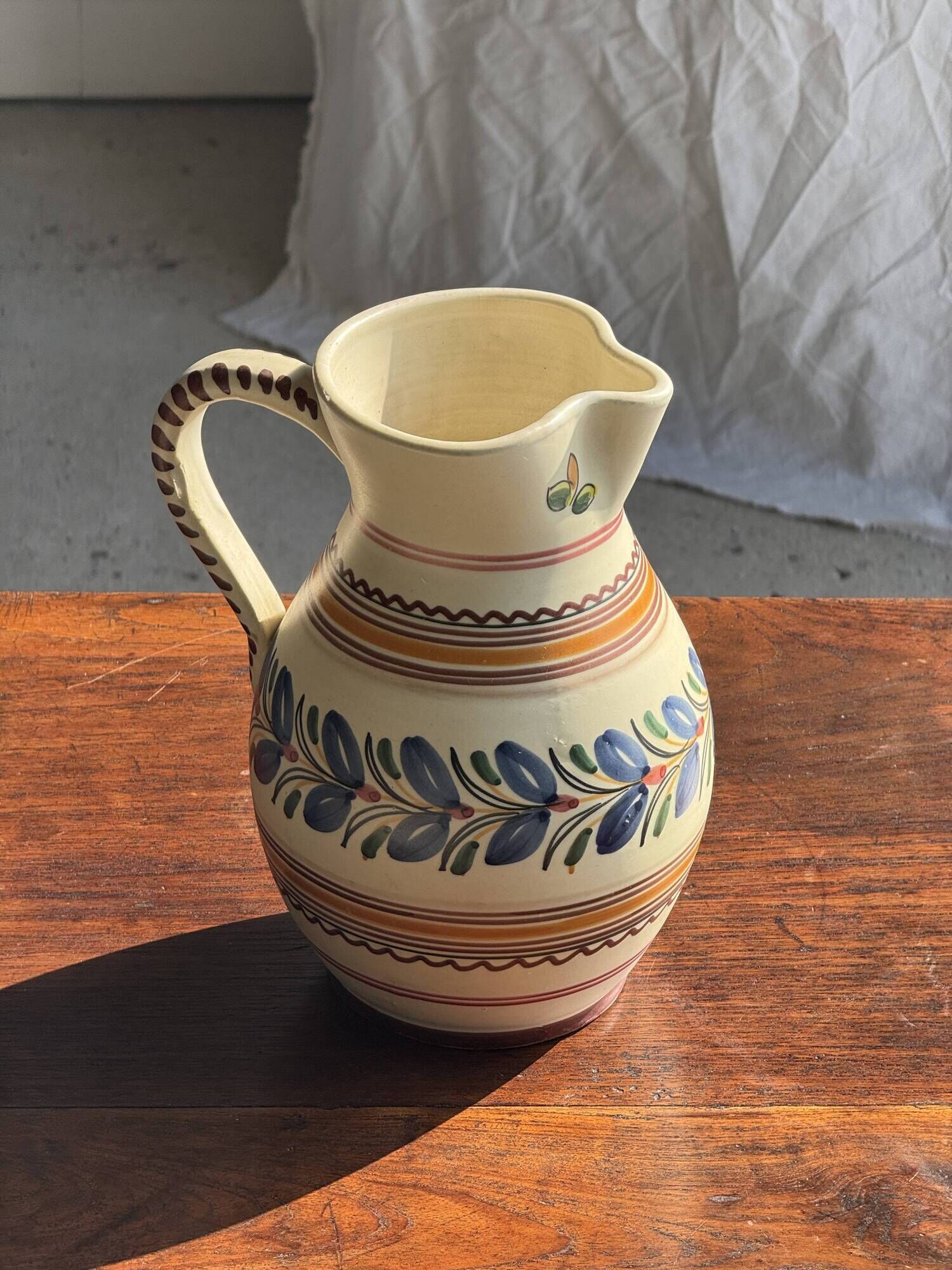 Beige carafe with stylized blue flower friezes