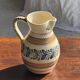 Beige carafe with stylized blue flower friezes