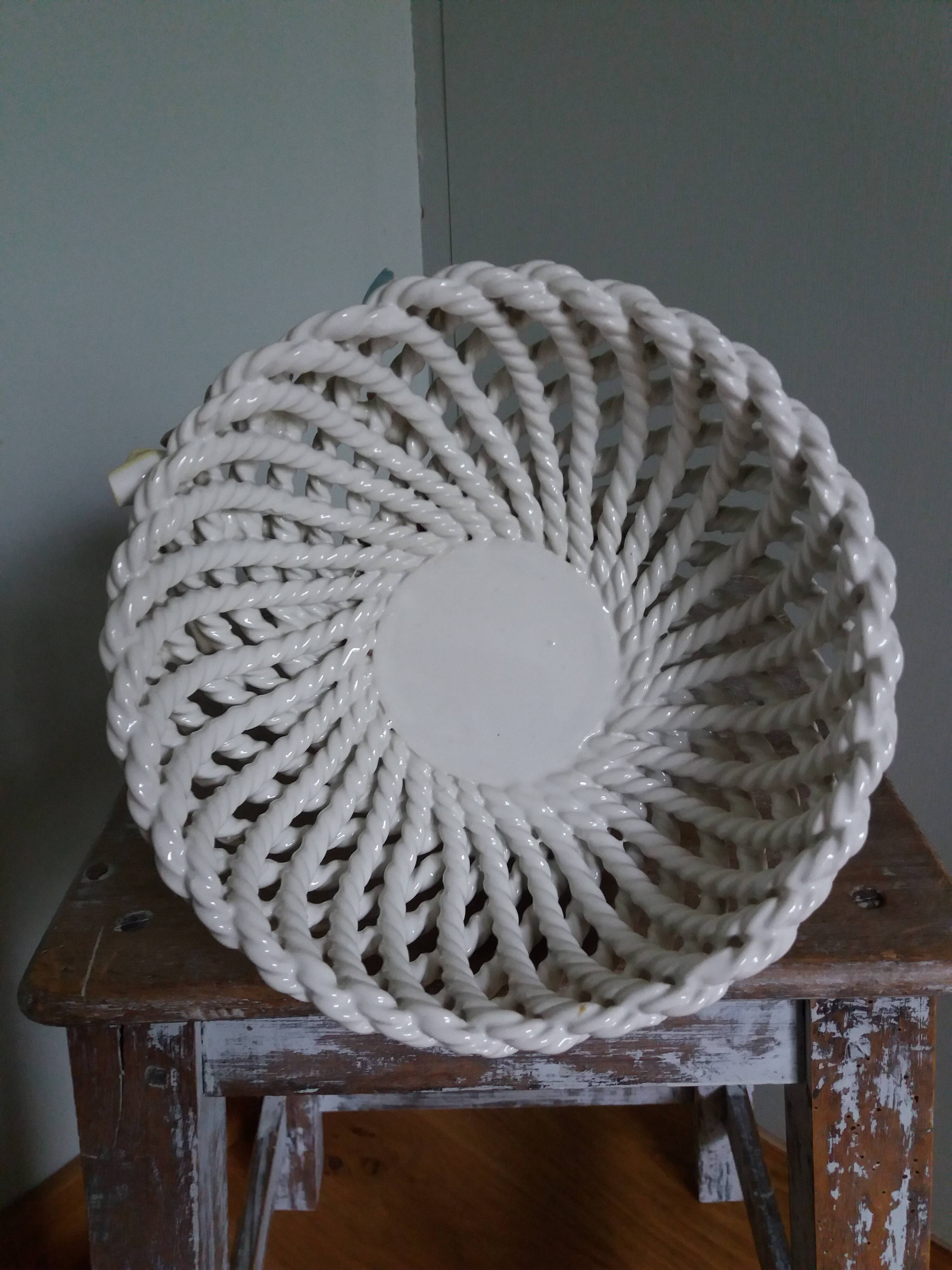 Cup on woven ceramic base with slip flowers