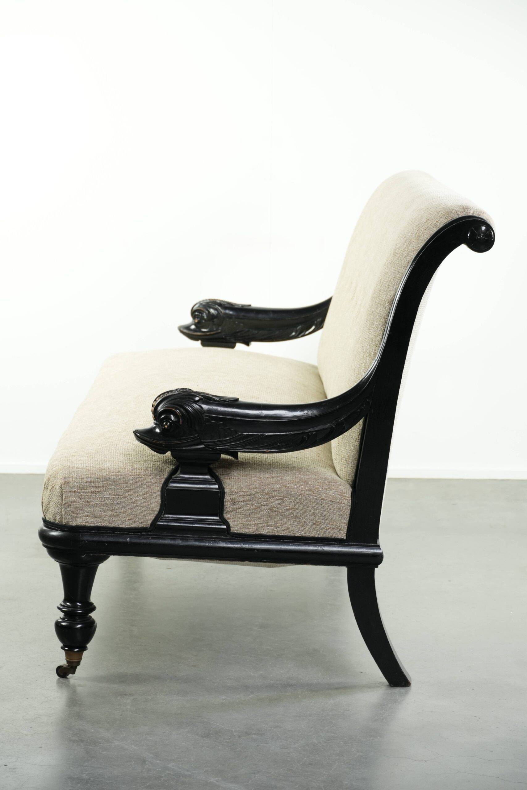French sofa from the 19th century in Empire style with detailed armrests