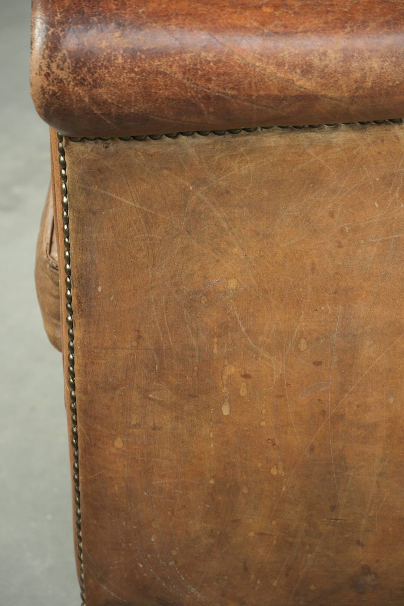 Vintage sheepskin club armchair finished with decorative nails