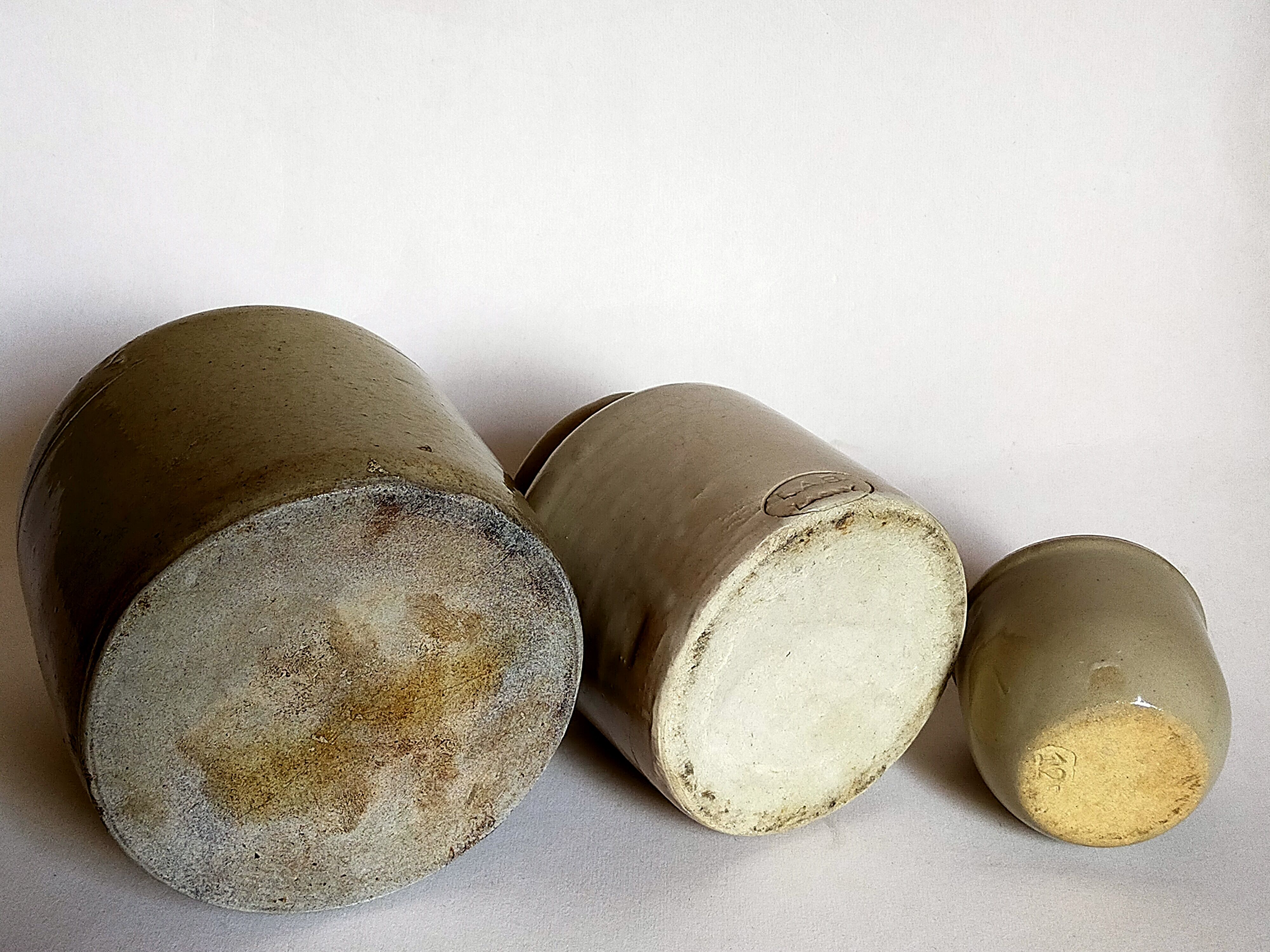 Set of three pots with old condiments in glazed earth