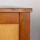 Vintage 1960s chest of drawers with covered handles.