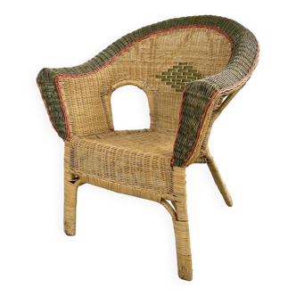 Cabriolet style armchair in rattan, wicker and green and red edging