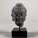 Sculpture of a Buddha head in grey schist from Gandhara, ancient Greece.