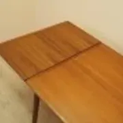 Danish extendable dining table, teak veneer, solid wood legs, leaf storage, 1970s