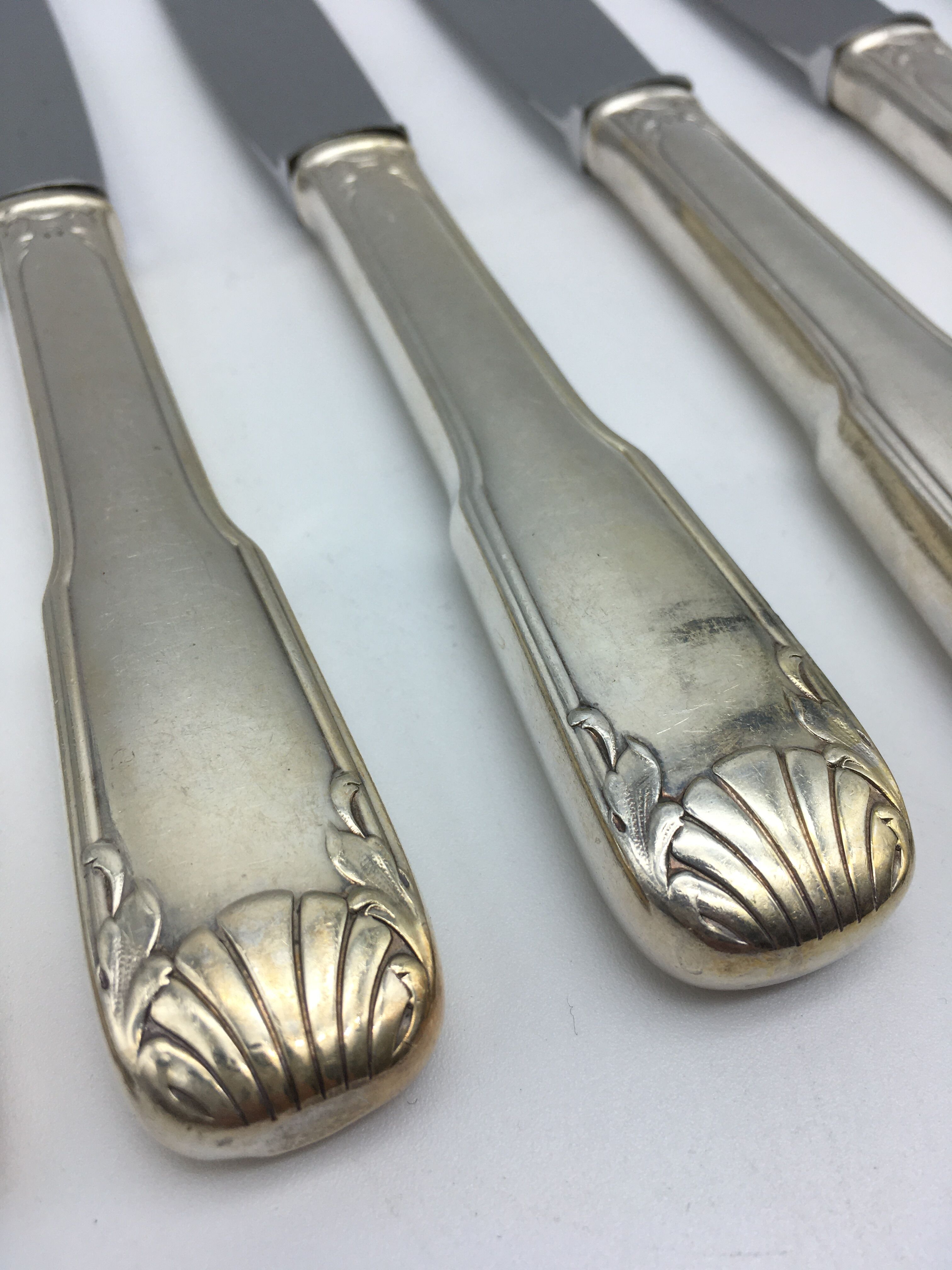 12 silver metal knives.