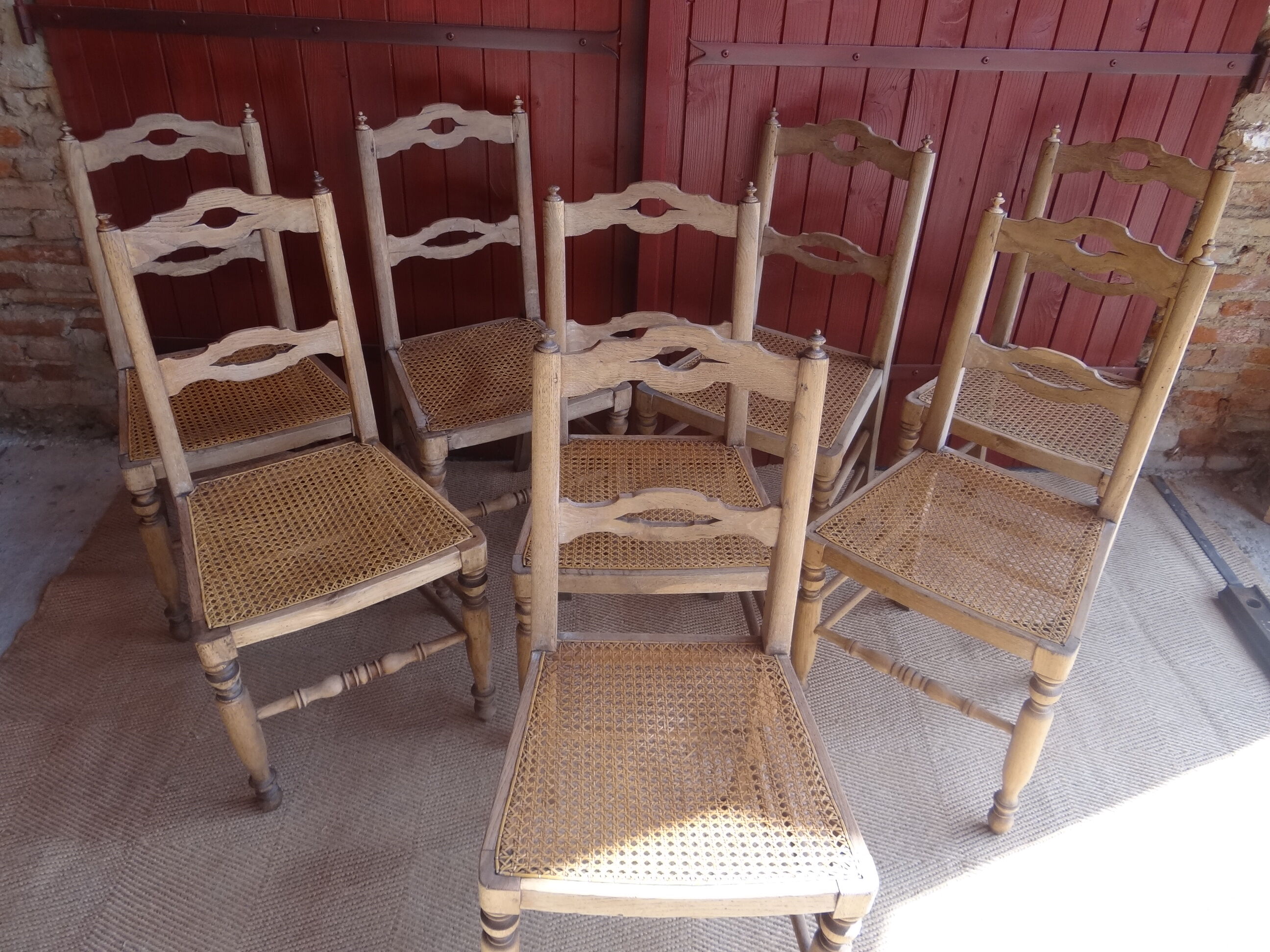 Suite of oak chairs; canated seats