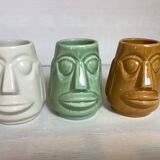 Set of three small Moai-style head vases.