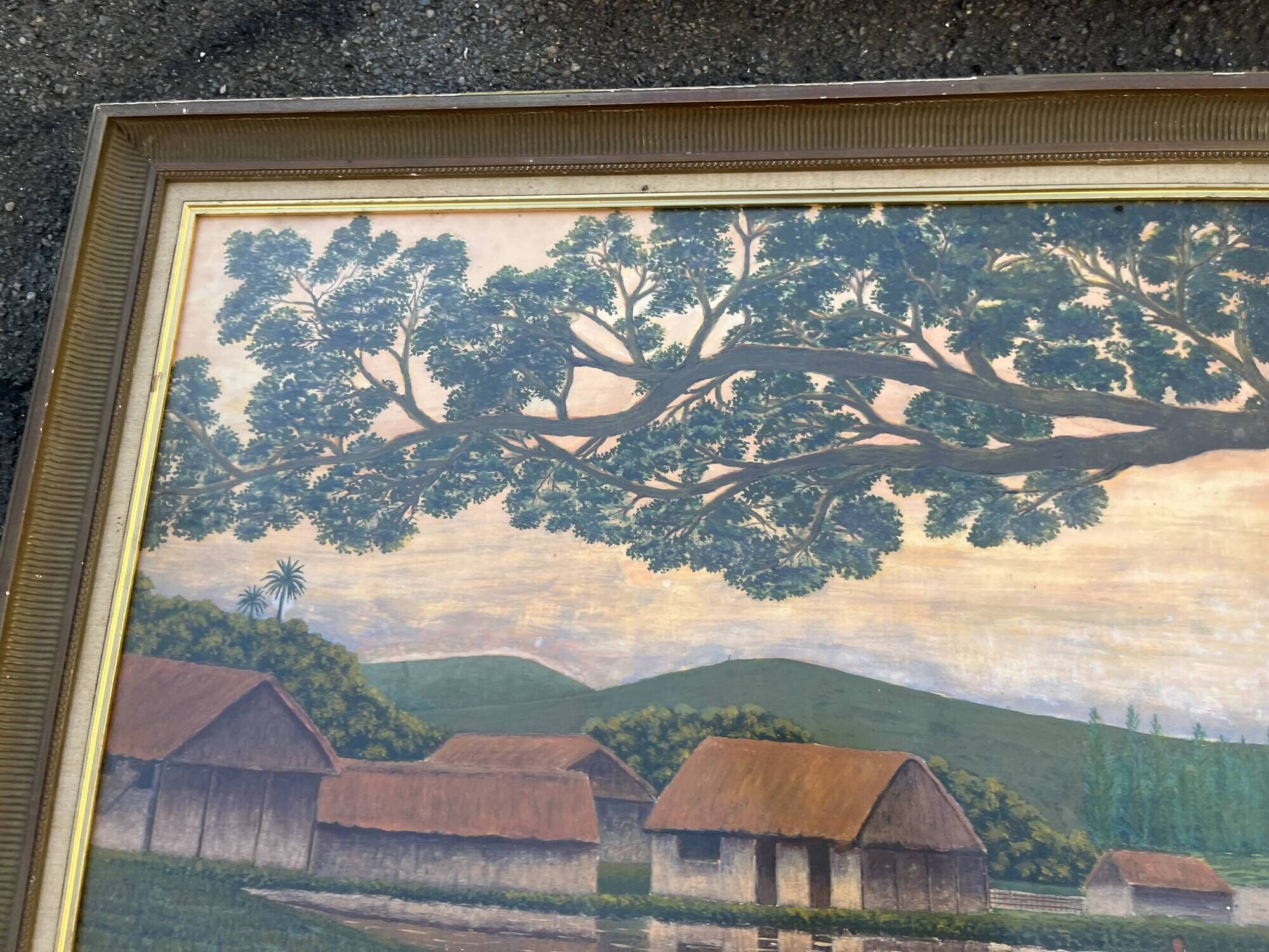 Large naive oil painting signed Medrano: rice field and buffalo, village with roofs of