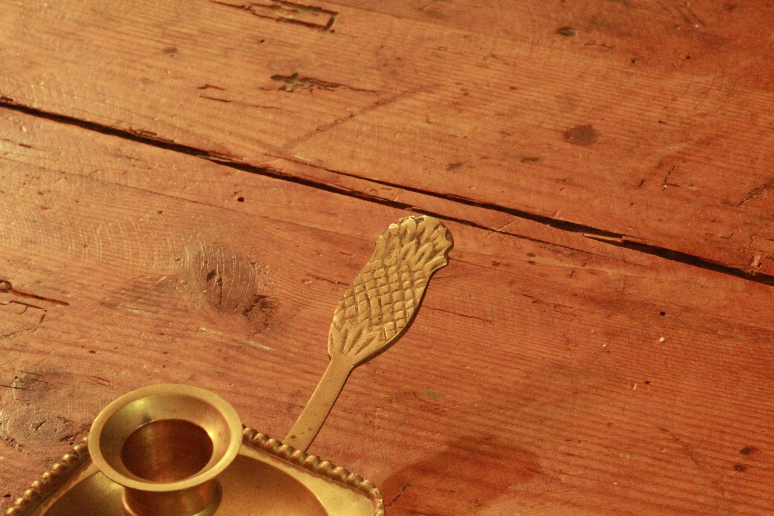 Old brass hand candle holder