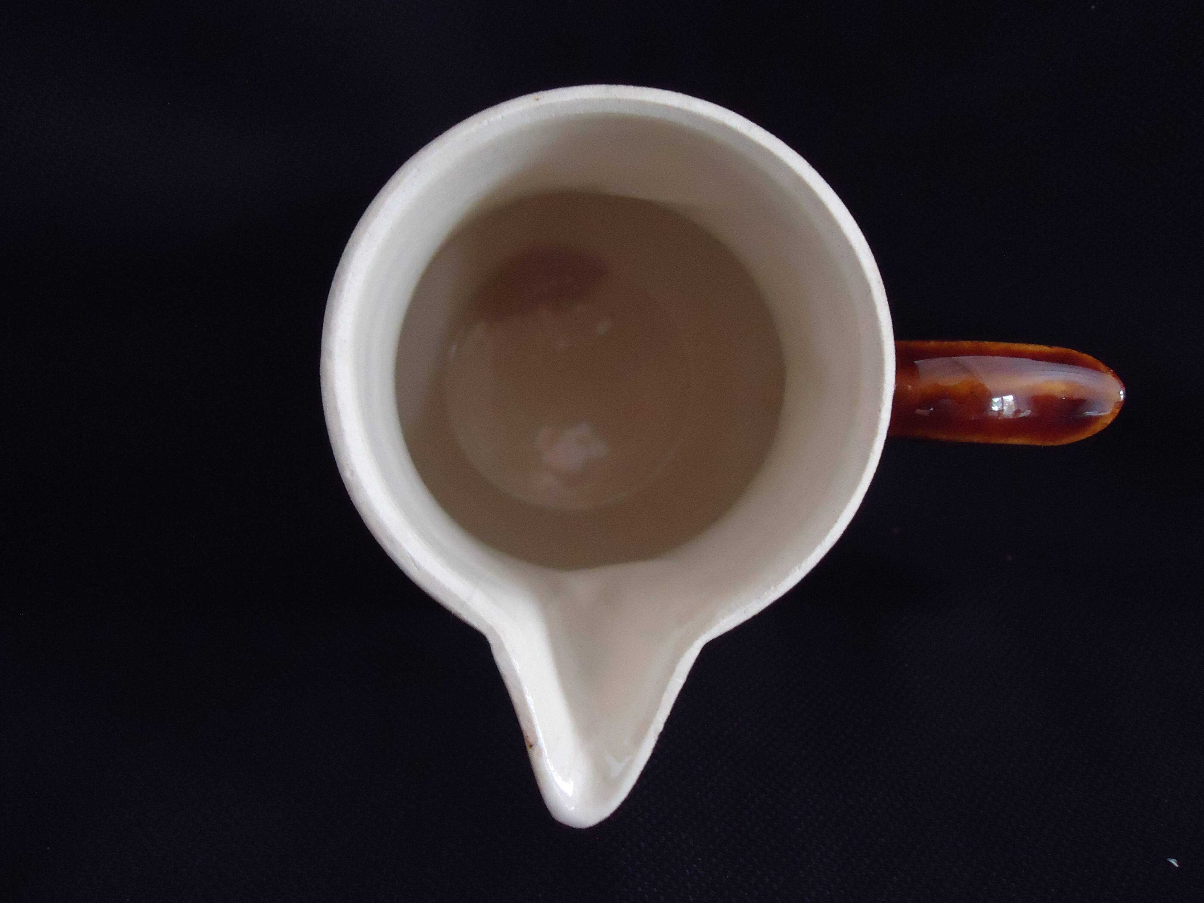 Old covered milk jug, side handle