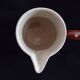 Old covered milk jug, side handle