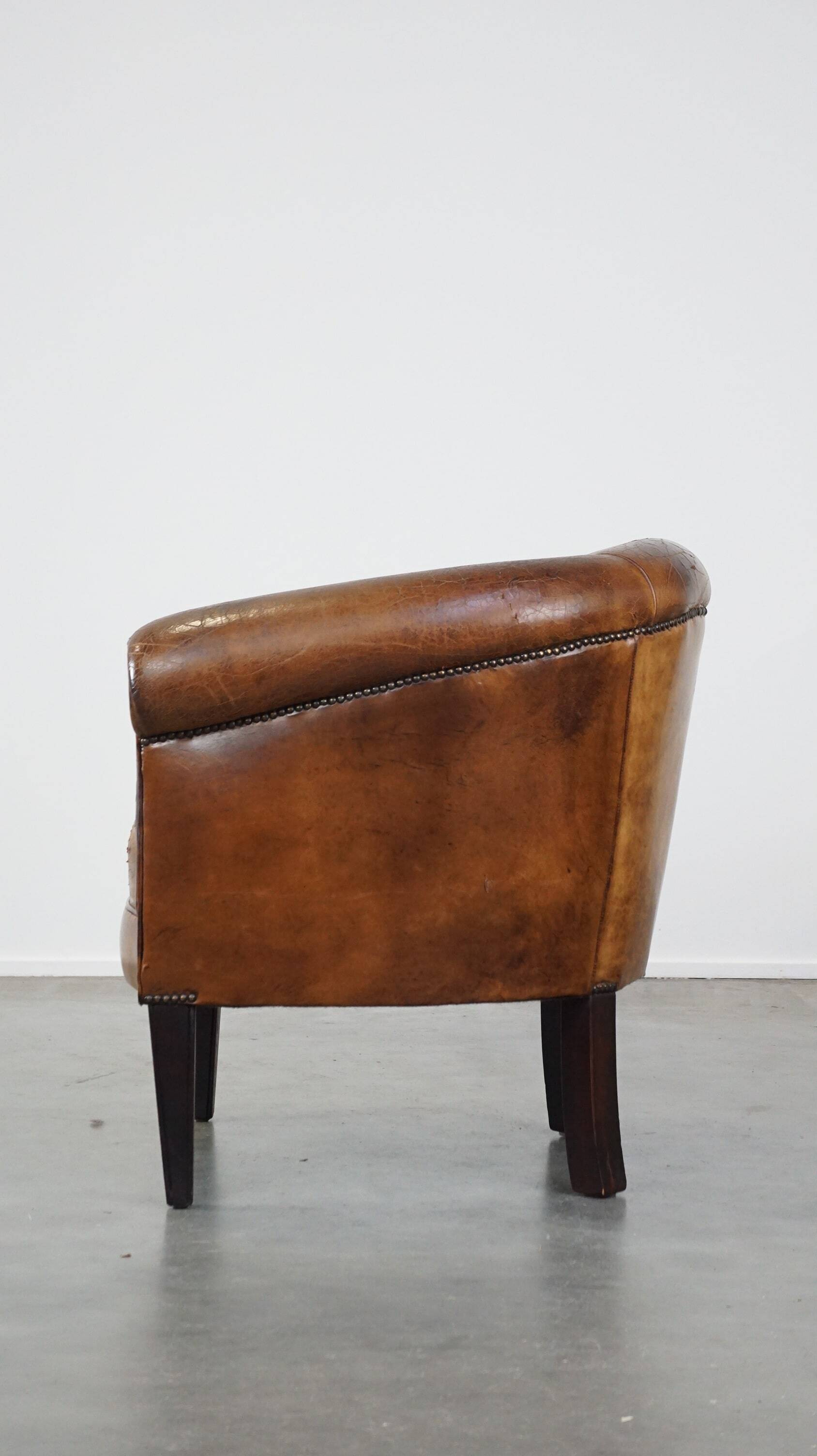 Sturdy, stately and subtle vintage sheepskin club chair