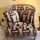 Armchair in a wooden confessional style with black and beige cotton.