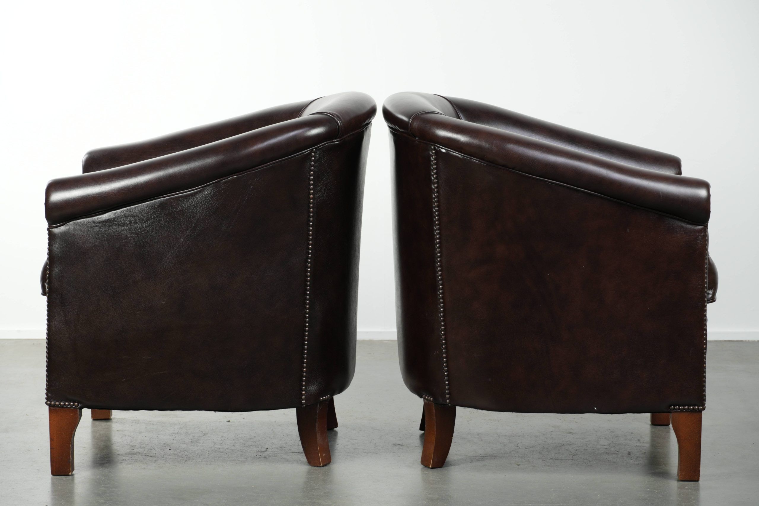 Set of two cowhide club armchairs in good condition with a English design