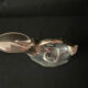 Glass decanter and silver metal duck