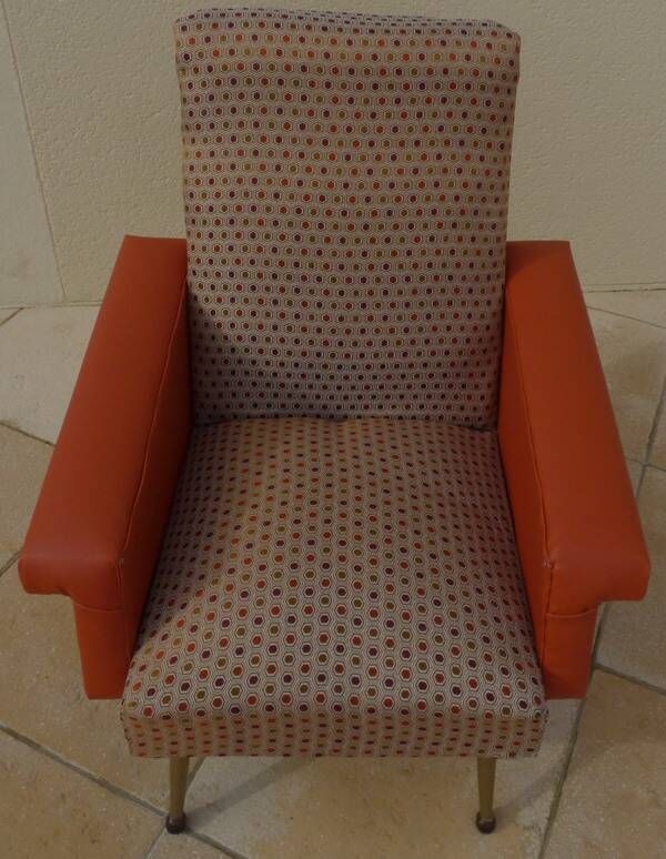 Vintage rockabilly retro armchair in orange faux leather and fabric.
