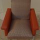 Vintage rockabilly retro armchair in orange faux leather and fabric.