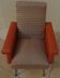 Vintage rockabilly retro armchair in orange faux leather and fabric.