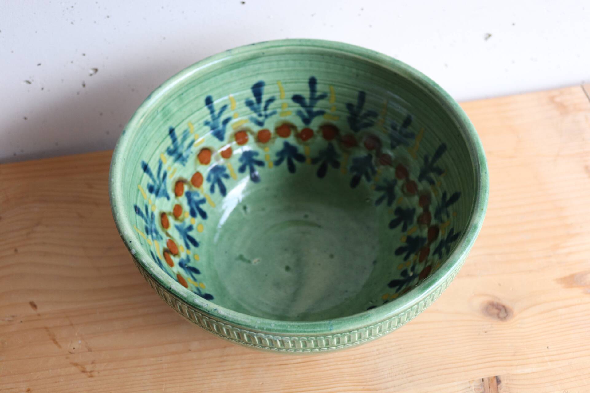 Large glazed ceramic salad bowl with a floral design.