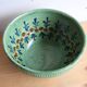 Large glazed ceramic salad bowl with a floral design.