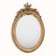 French 19th-century oval mirror in gold leaf with a pediment.