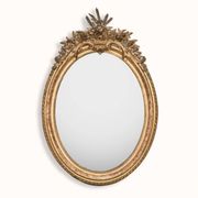 French 19th-century oval mirror in gold leaf with a pediment.