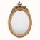 French 19th-century oval mirror in gold leaf with a pediment.