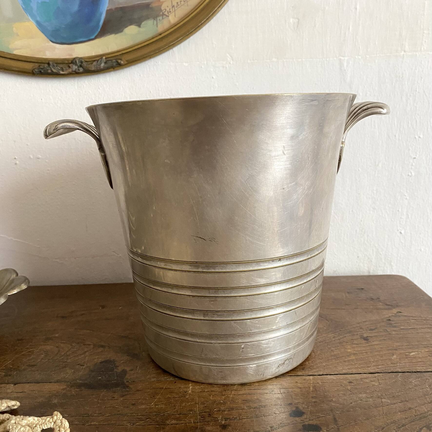 Antique champagne bucket with shell handles.