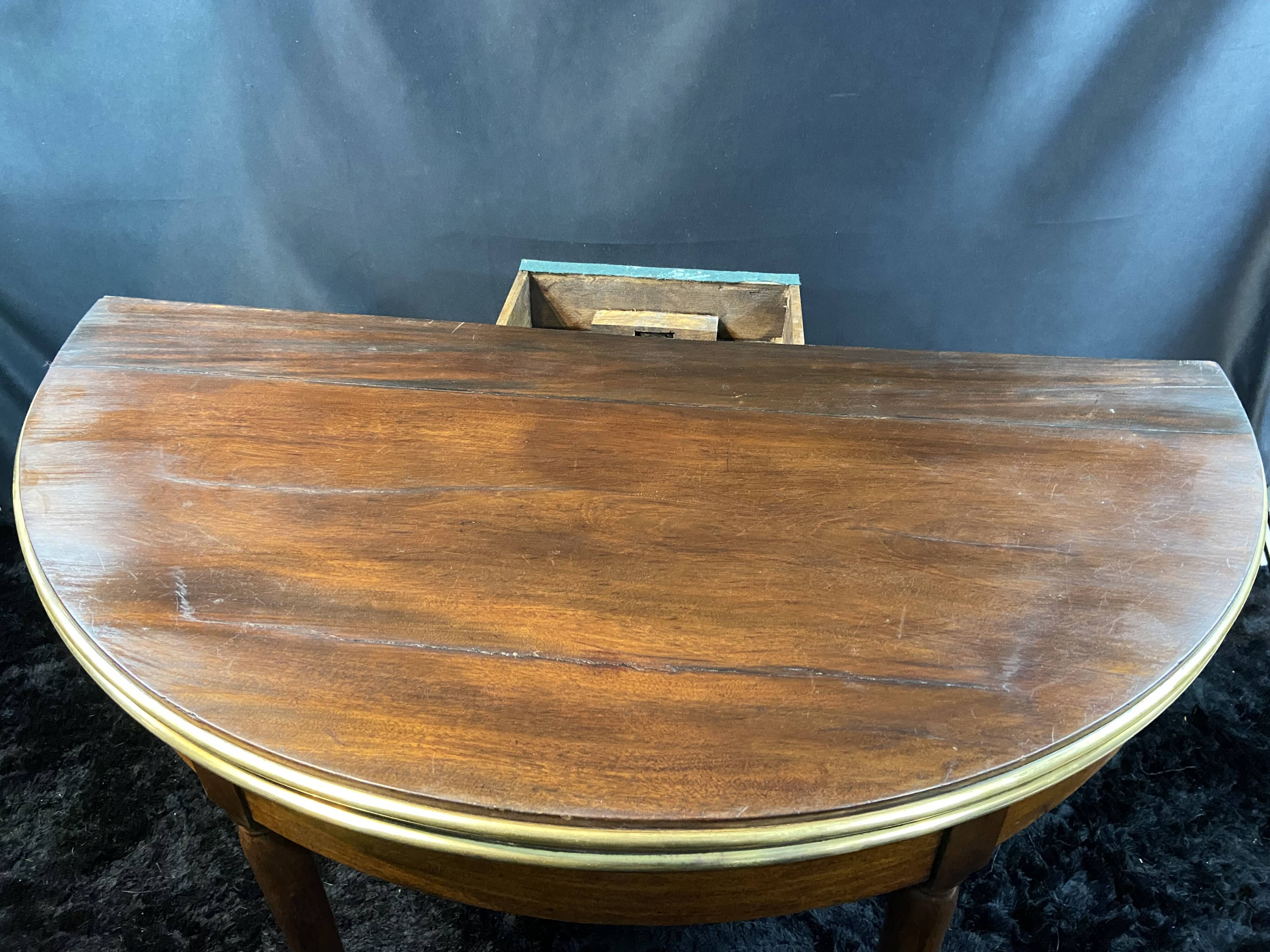 A Louis XVI period mahogany half-moon table forming a console/games table